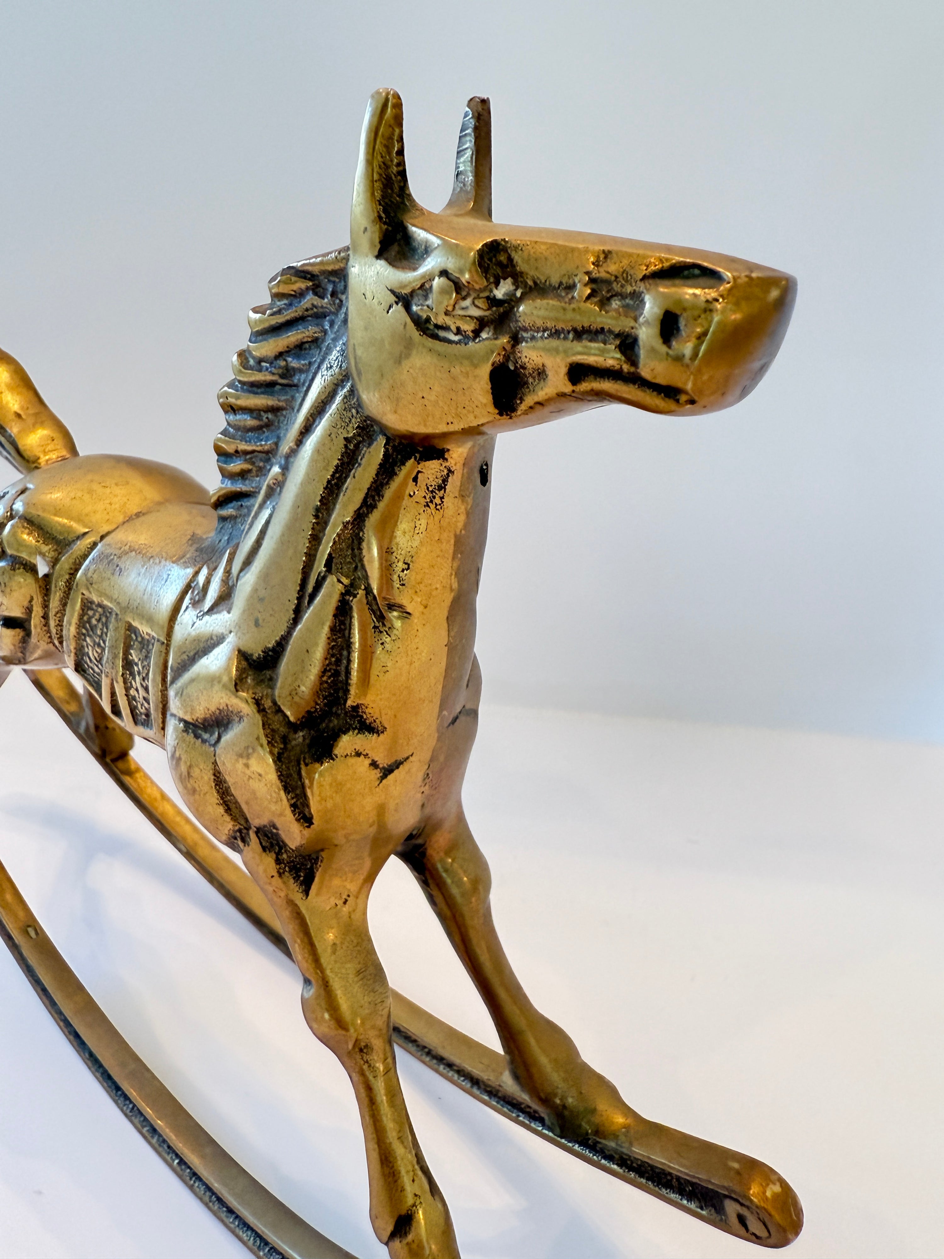 Brass rocking horse sculpture, side view