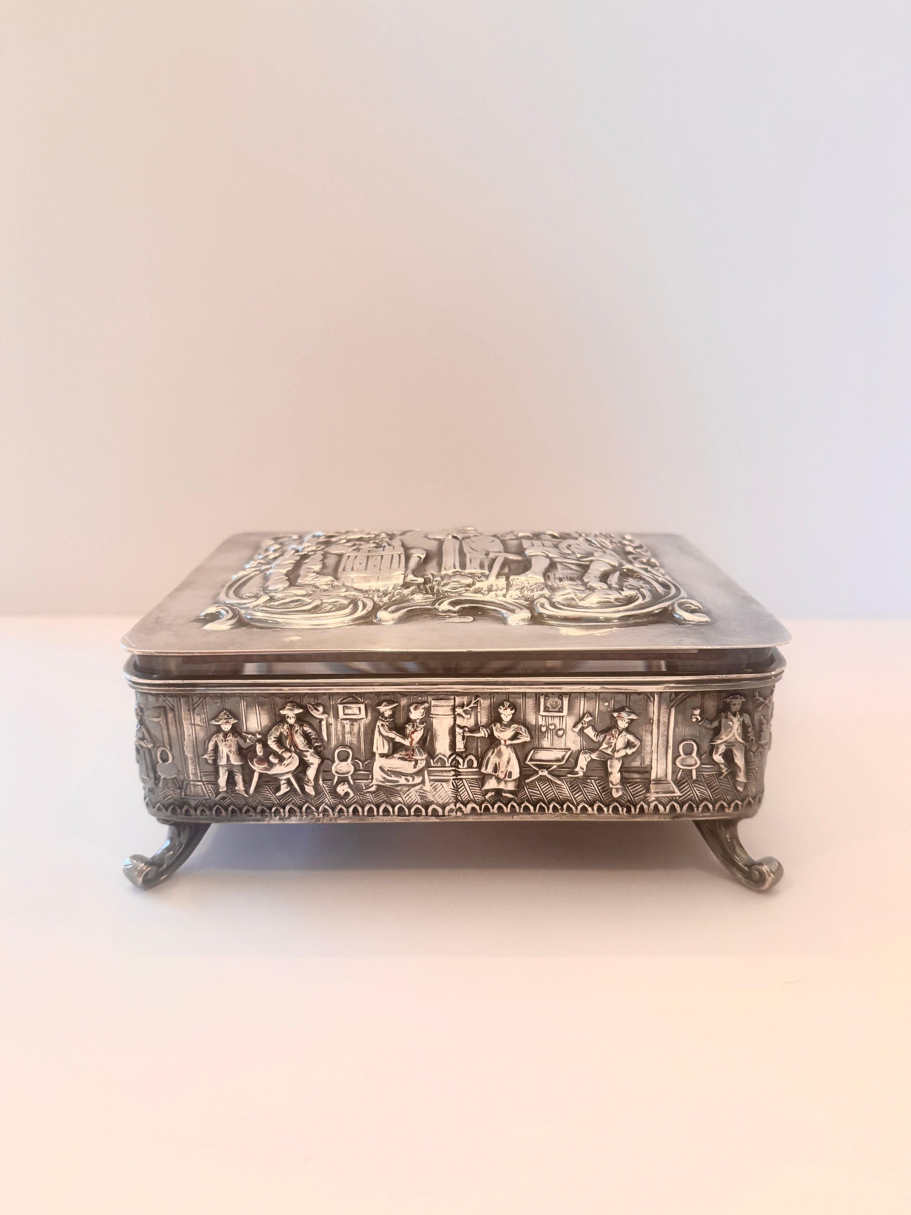 Vintage stamped silver box with an embossed scene on the lid