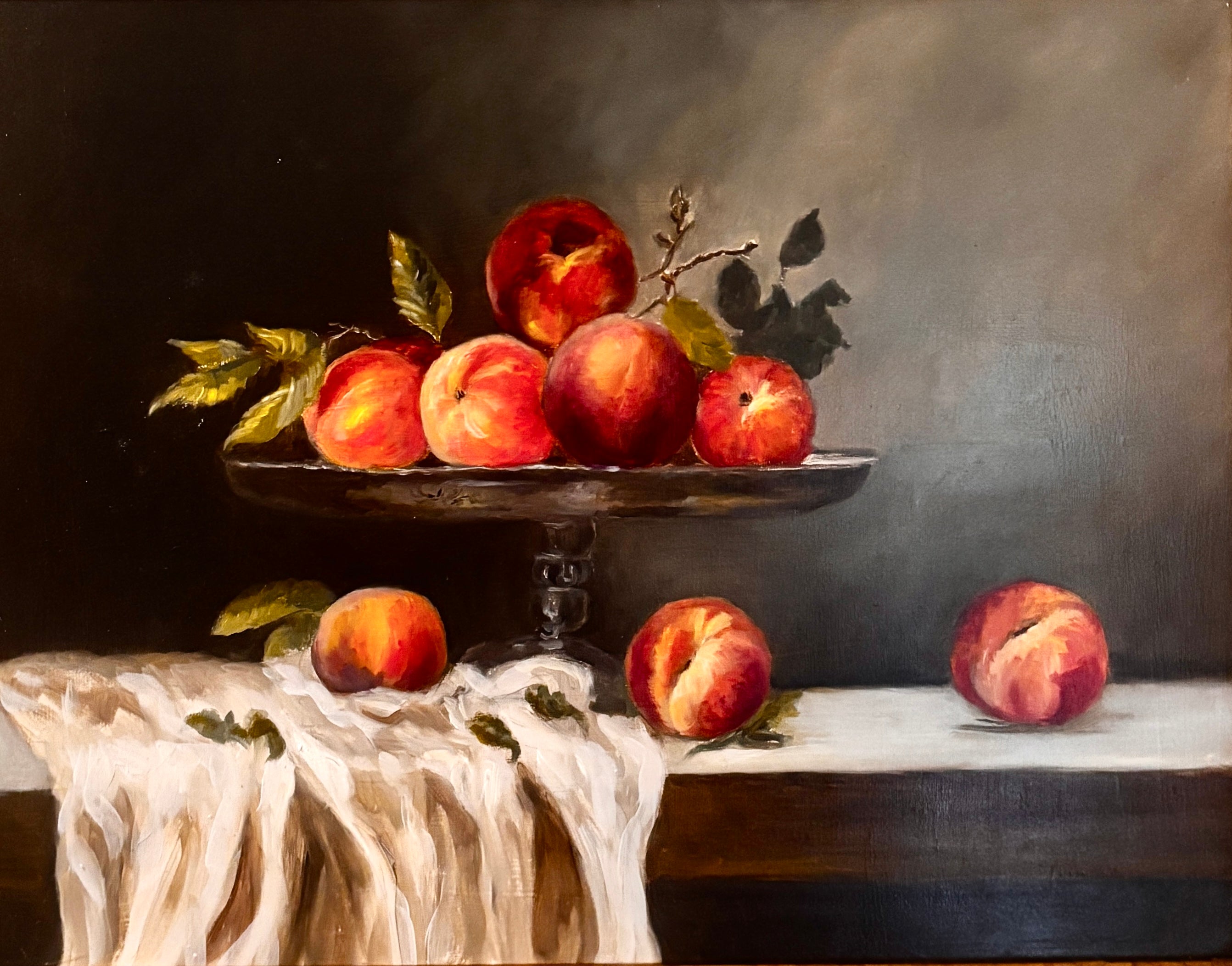 Vintage oil still life of peaches on a glass pedestal with draped cloth