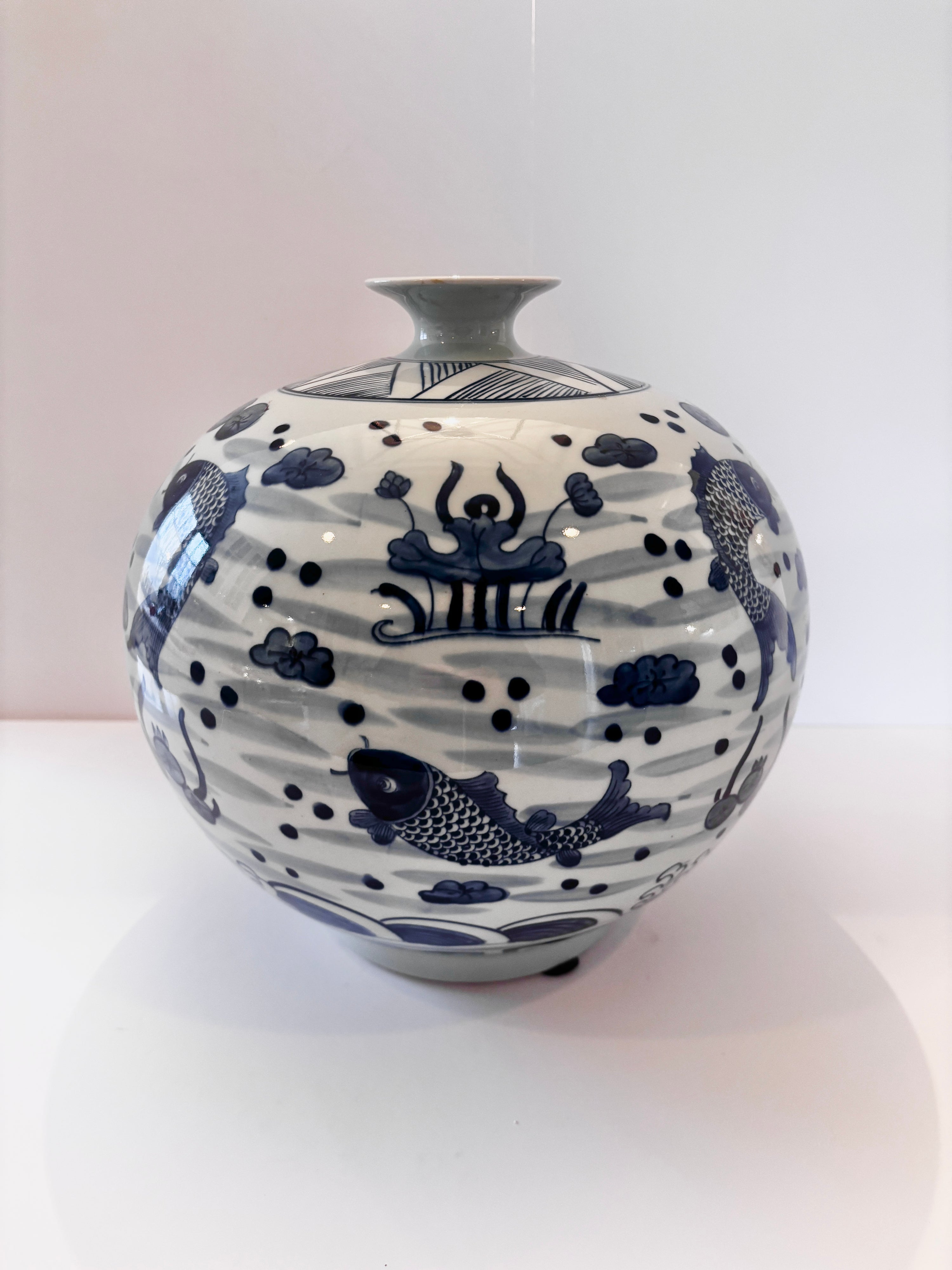Hand-painted blue and white porcelain vase with a koi and wave motif