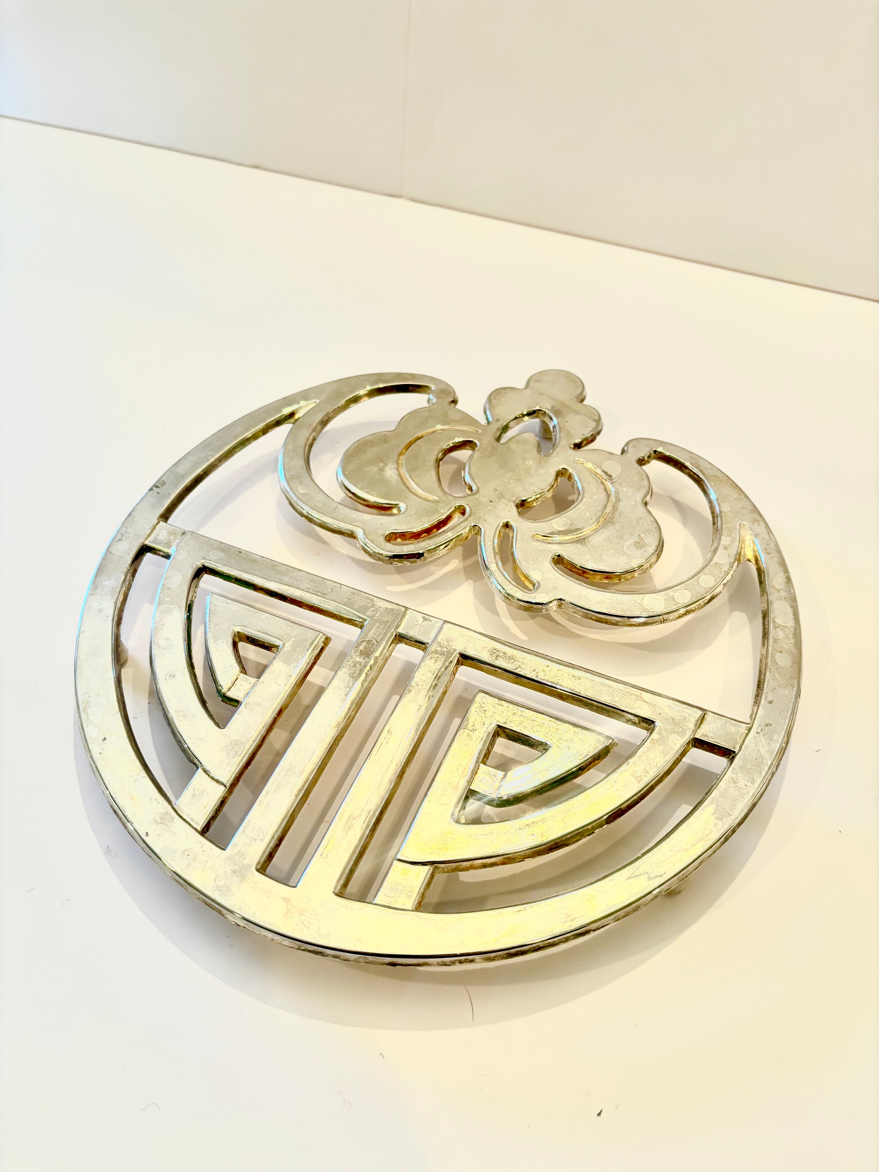 Silver-plated trivet, detail of the geometric and floral design
