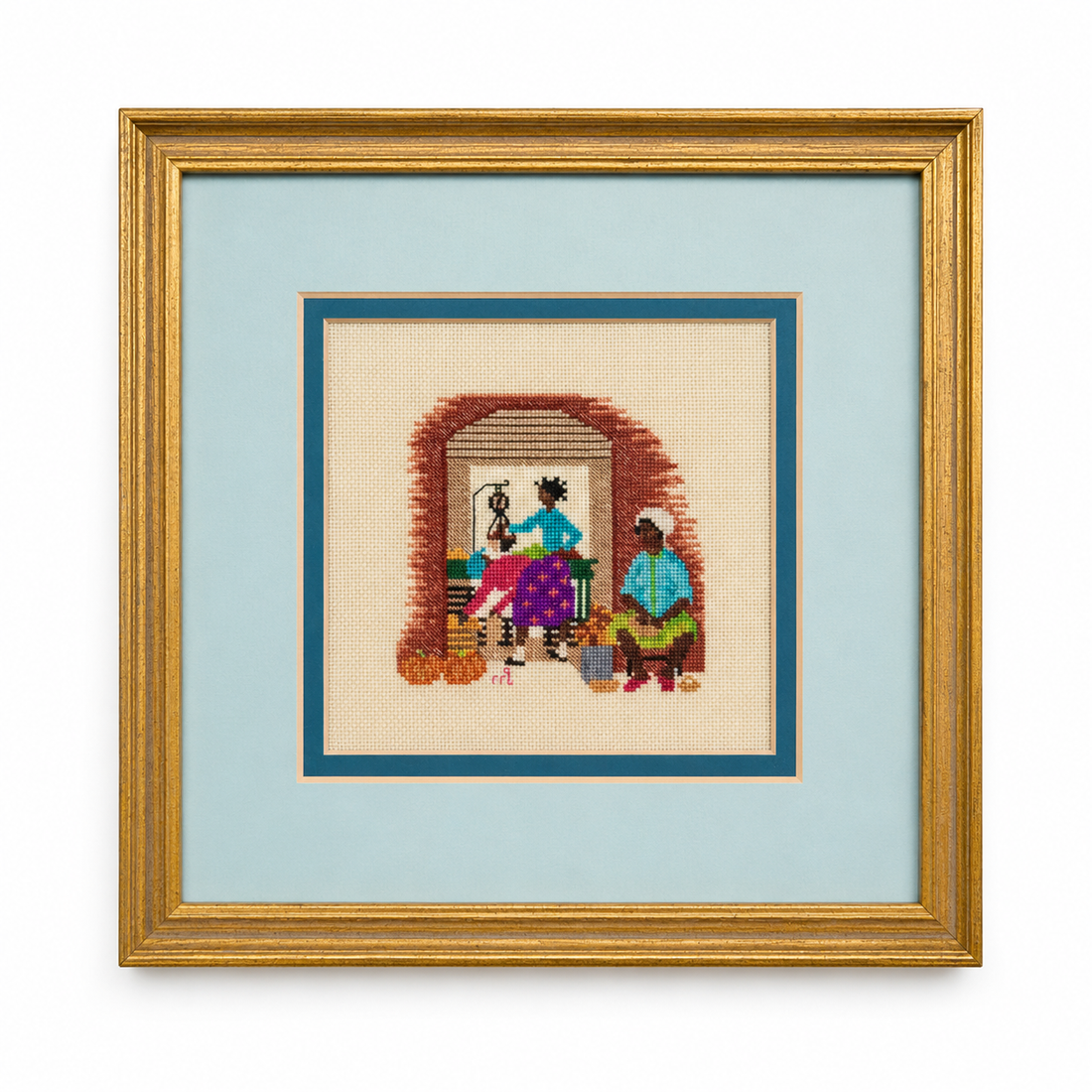 Scena domestica vintage con donne e zucche realizzata a punto croce