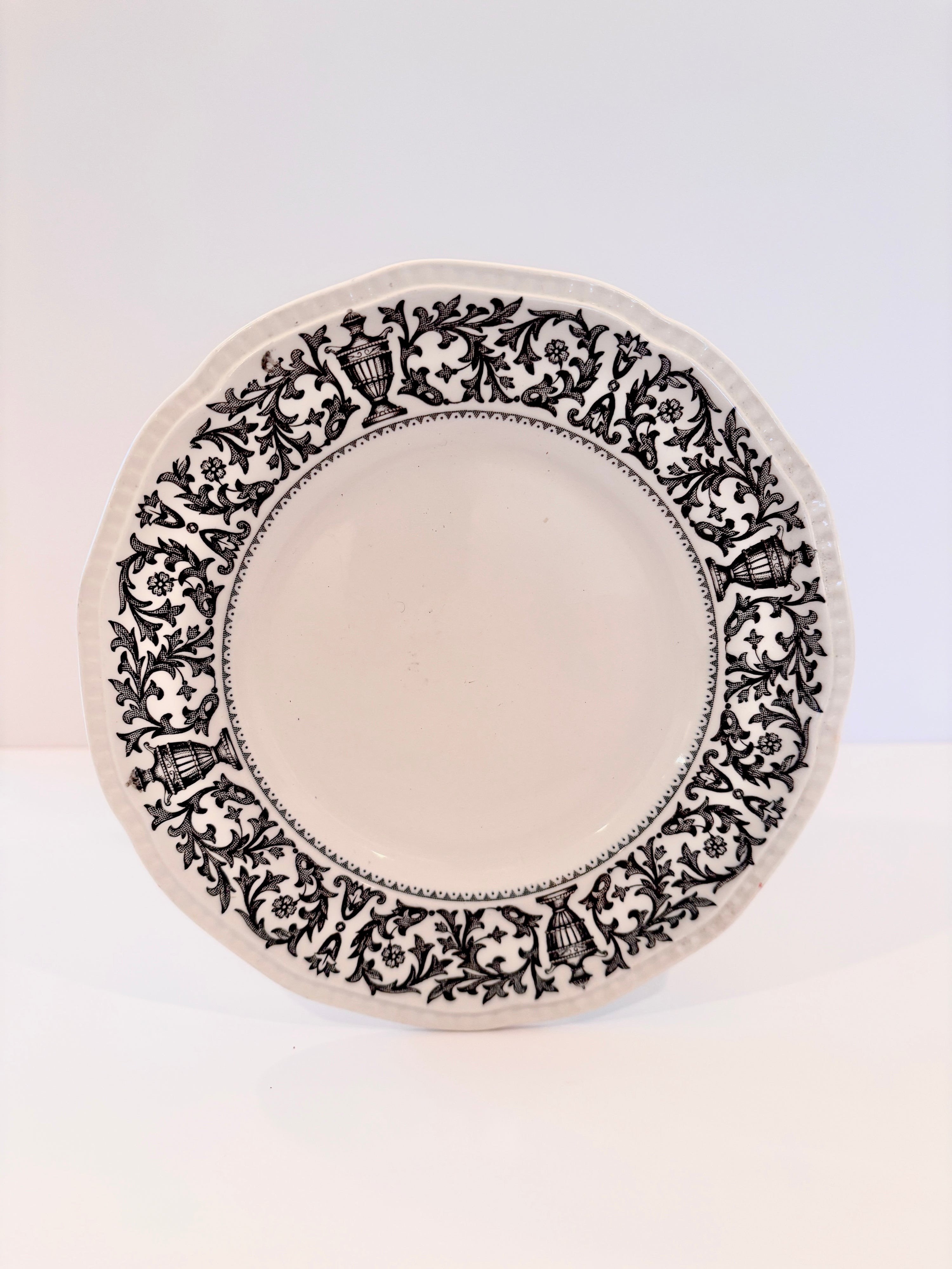 English Queen Anne ironstone plate with a black floral and urn motif on the rim, 6 inches