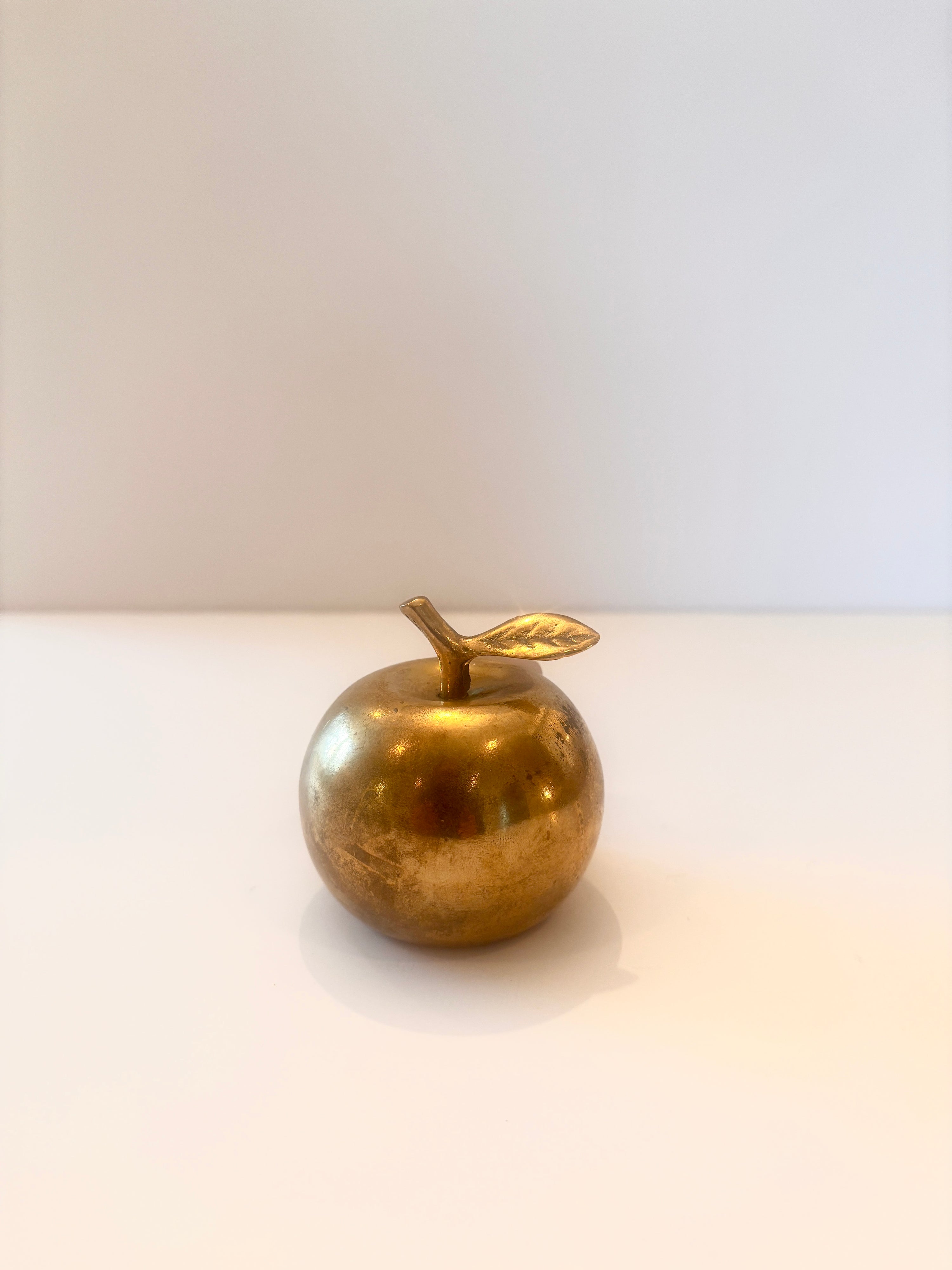 Vintage polished brass apple bell with a leaf stem, 2.5 inches