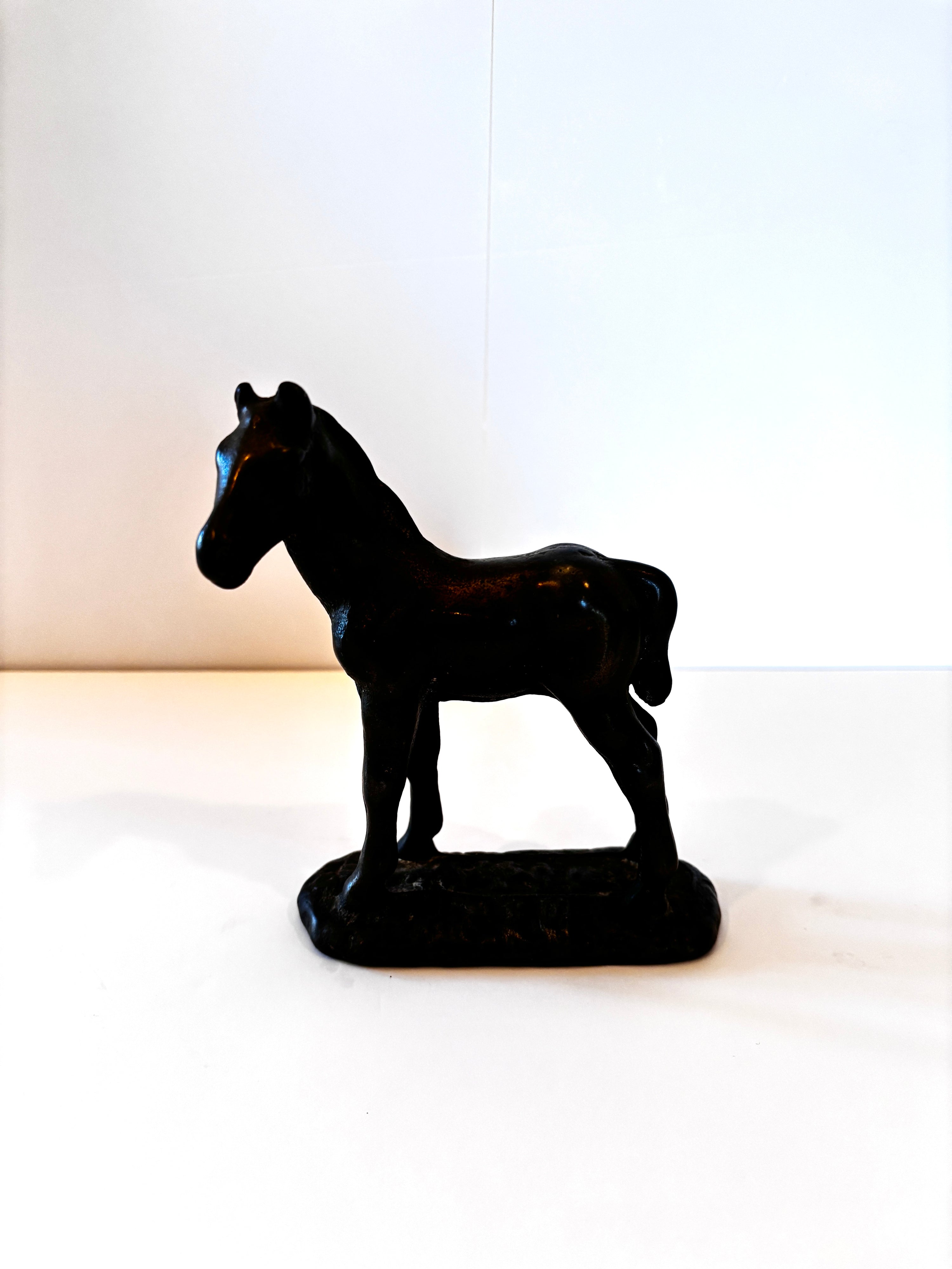 Vintage cast iron pony figurine, rustic finish, side view