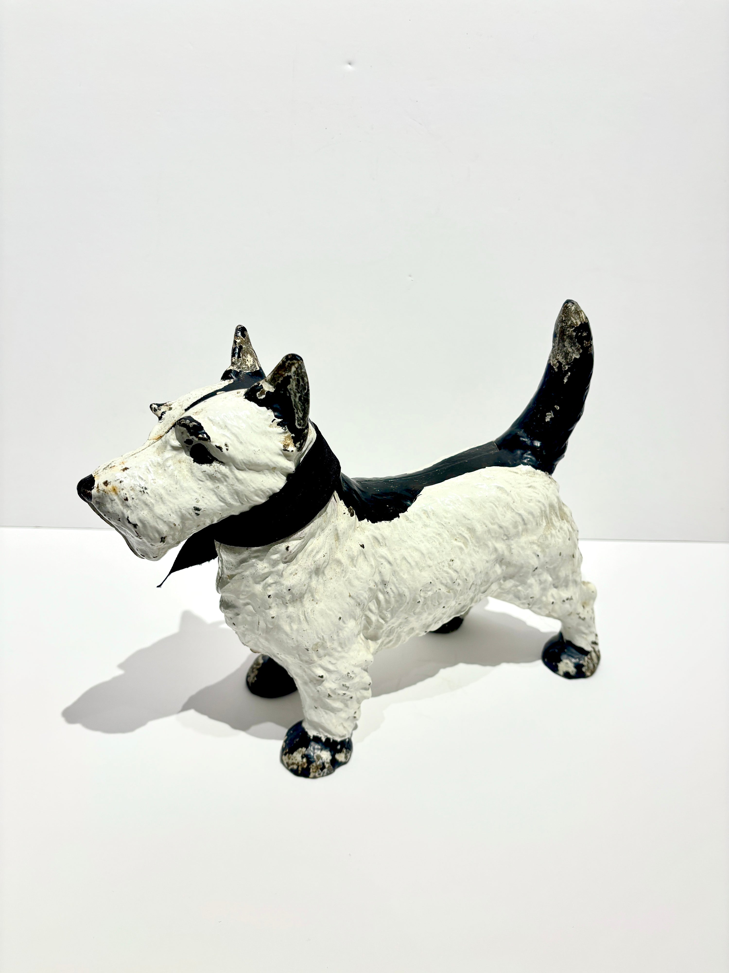 Vintage cast iron terrier door stopper, hand-painted black and white