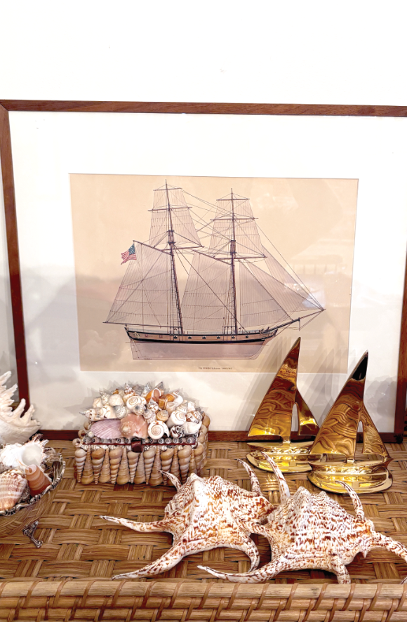 A framed print of a schooner and a set of nautical-themed sailboats