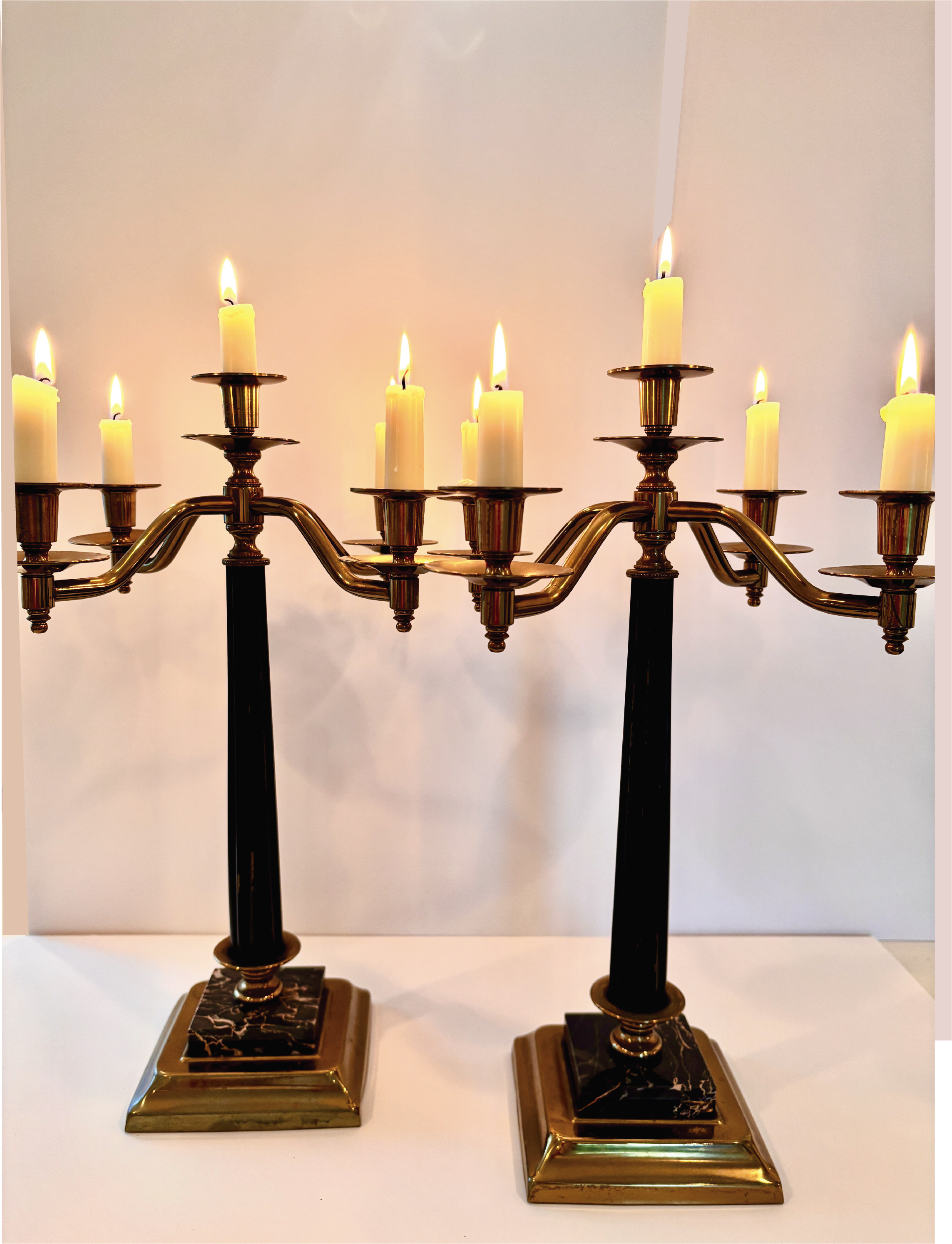 Pair of vintage candelabras with black onyx columns, marble bases, and five brass arms each