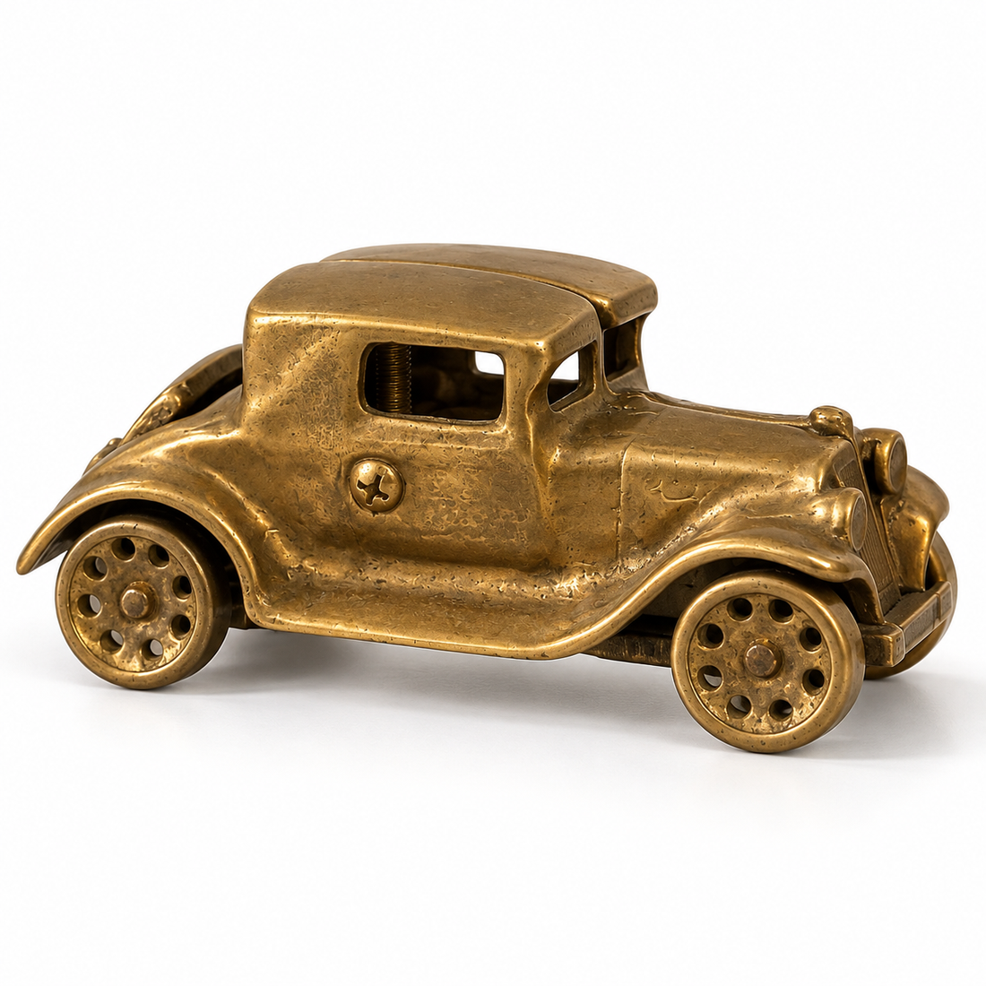 Vintage cast brass antique coupe car figure with spoked wheels, 2.5 inches tall, on a white background