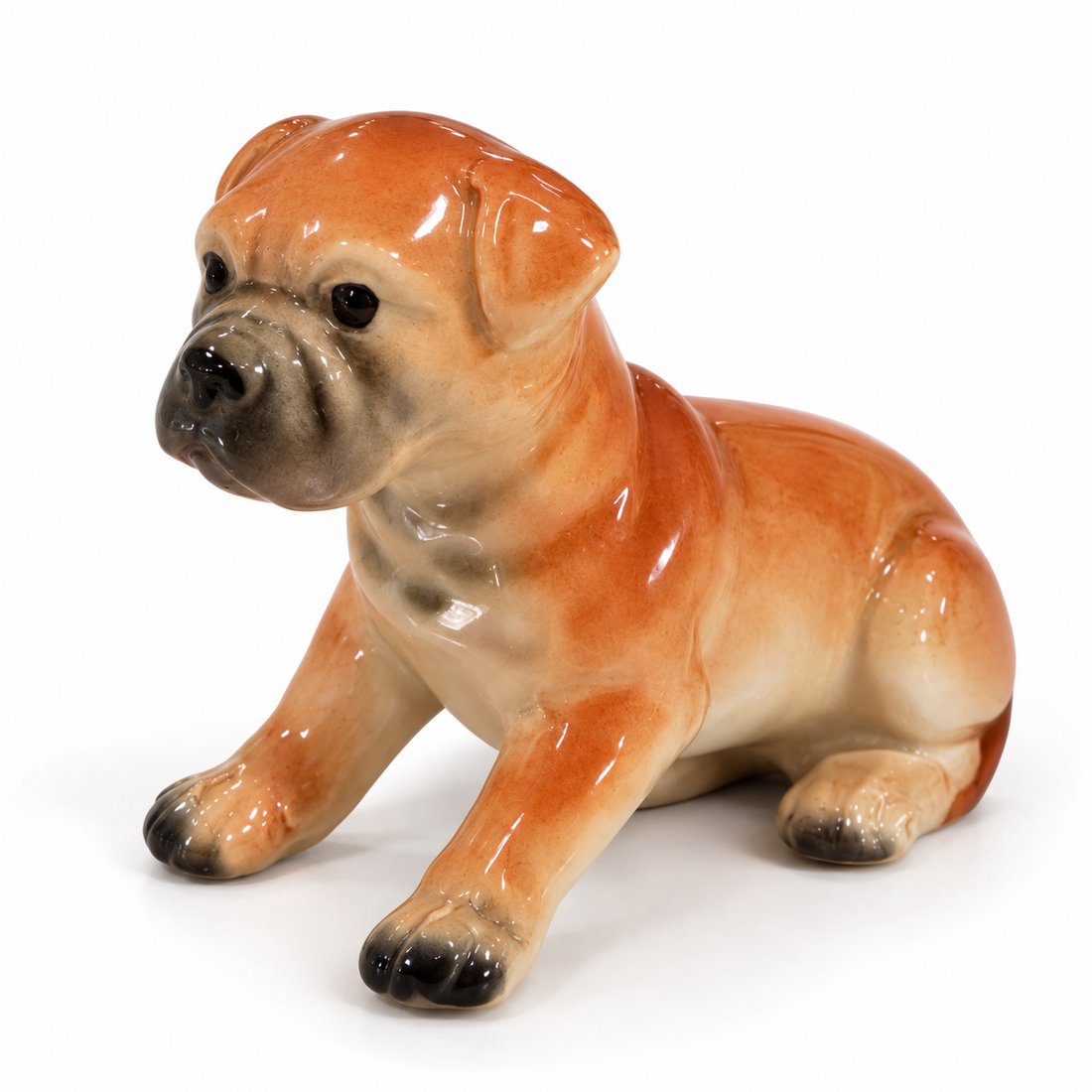 Vintage hand-painted fawn porcelain seated boxer puppy figurine, 2.5 inches tall, on a white background