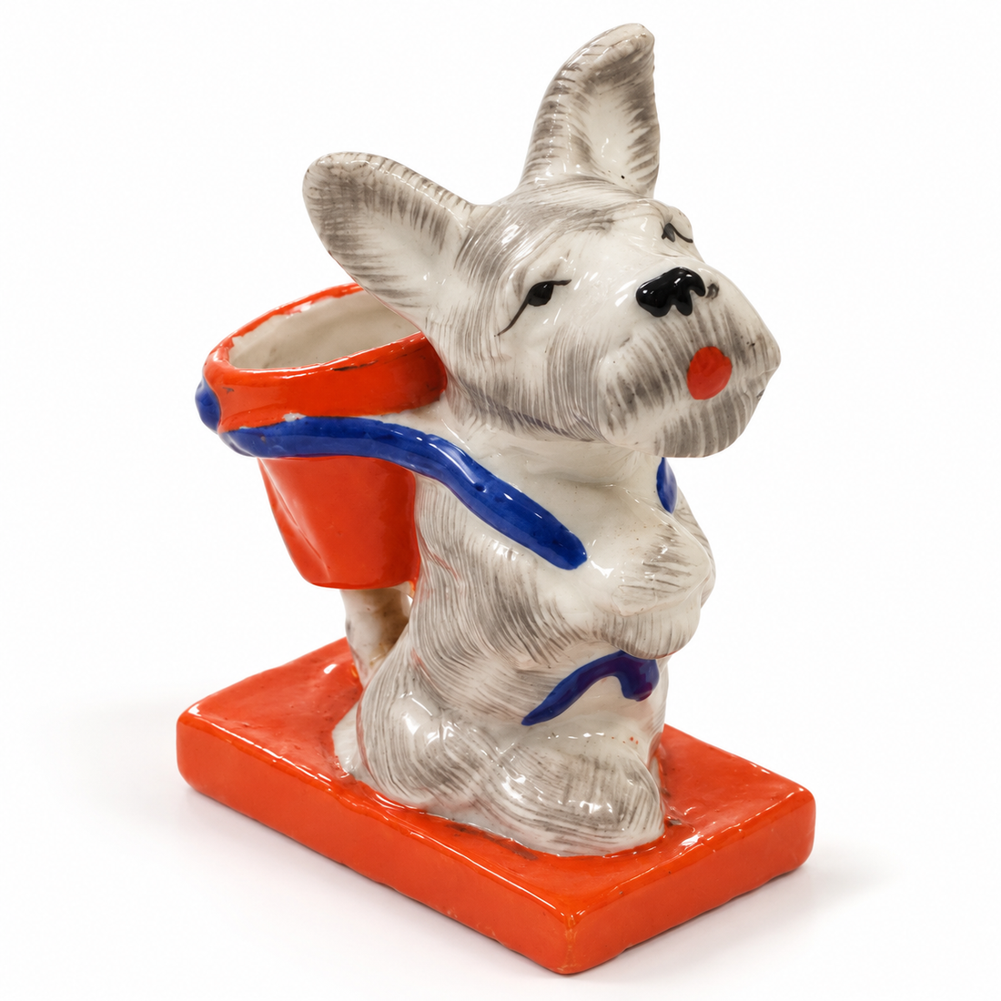 Vintage hand-painted porcelain Scottie dog match holder with orange basket and base on white background