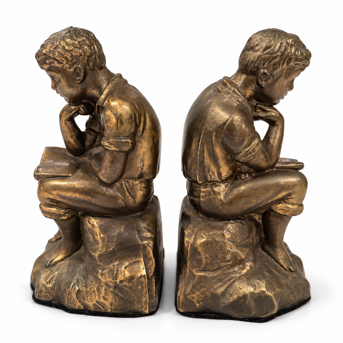 Bronze-tone metal reading boy bookends, side view on white