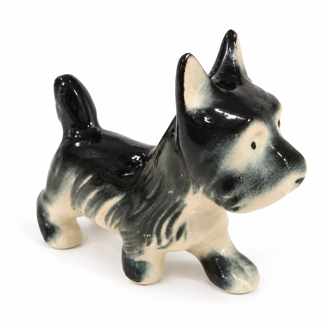 Vintage black and white Scottie dog figurine, three-quarter view from behind, on white background